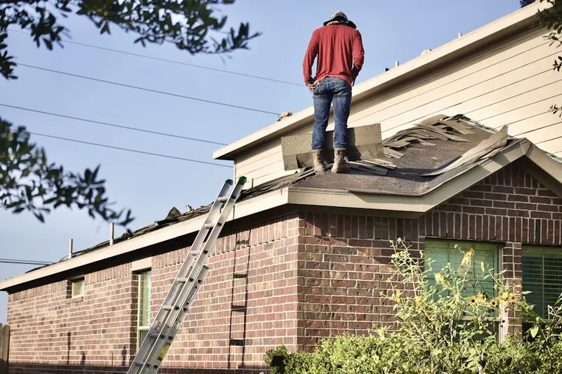 Professional roofer working on a residential roof in Maryland City